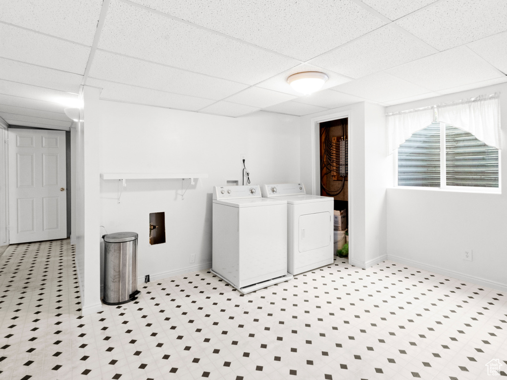 Laundry room with baseboards, washer and dryer, and laundry area