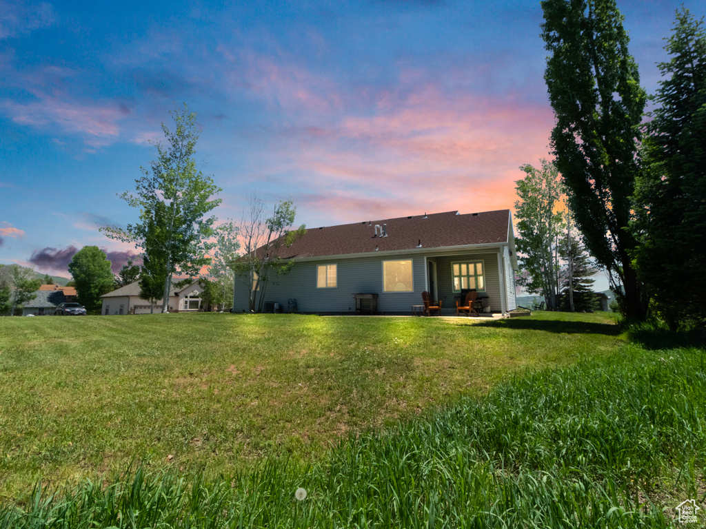 Back of house featuring a yard and a patio area