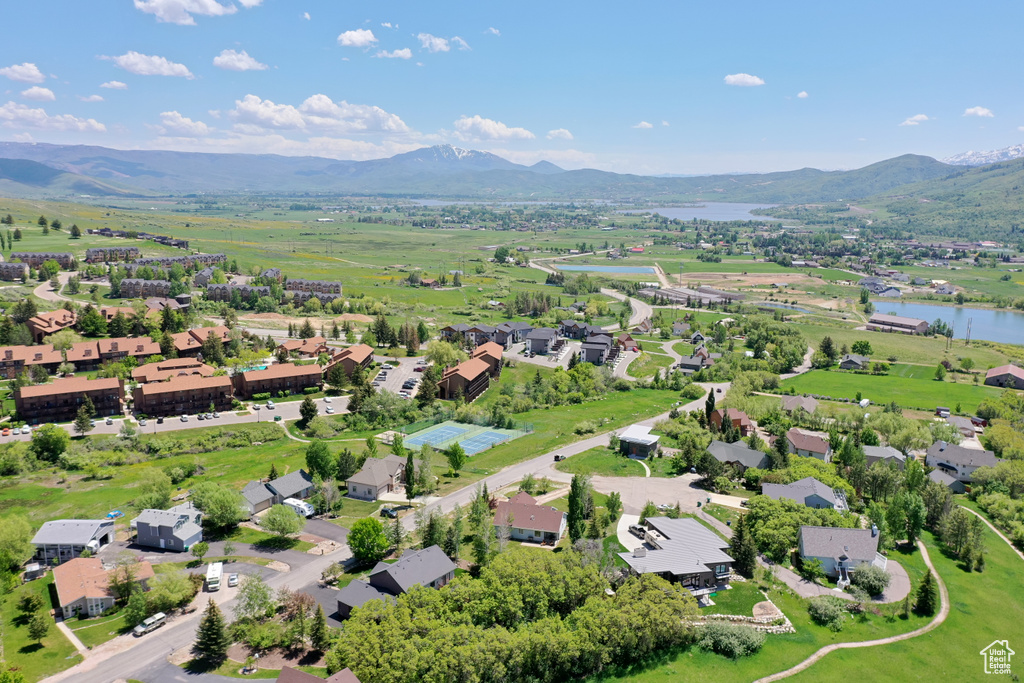 Drone / aerial view featuring a water and mountain view