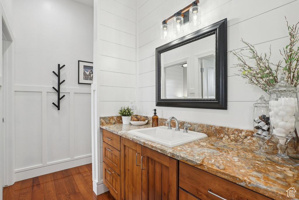 Bathroom featuring vanity and wood finished floors