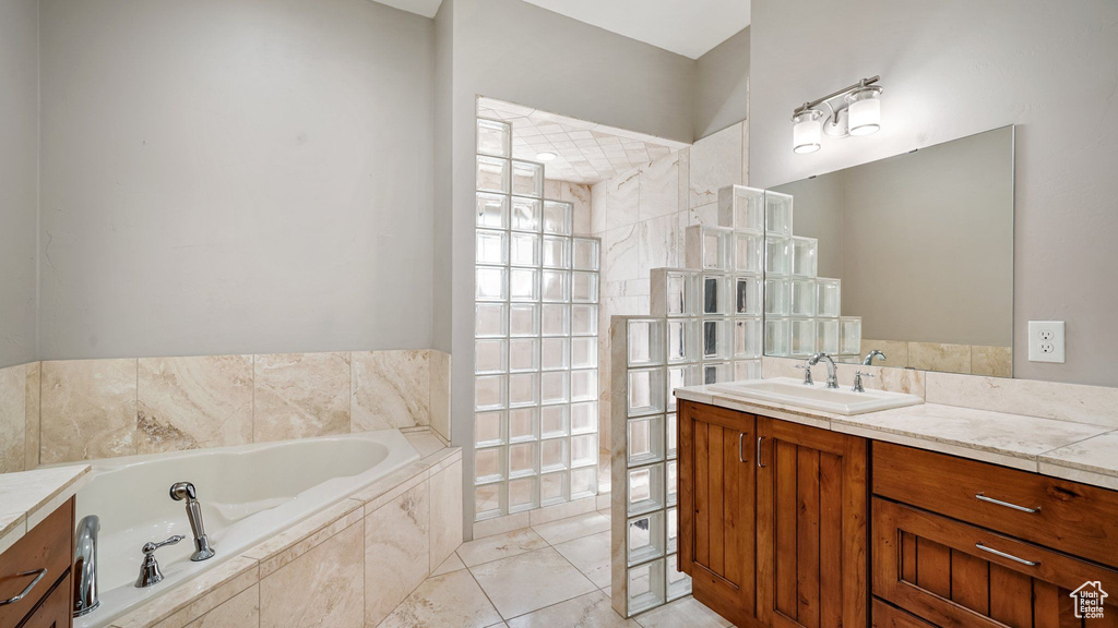 Bathroom with vanity and a bath