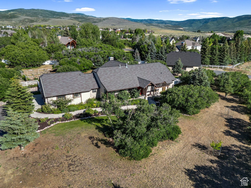 Aerial view of property and surrounding area with a mountain backdrop