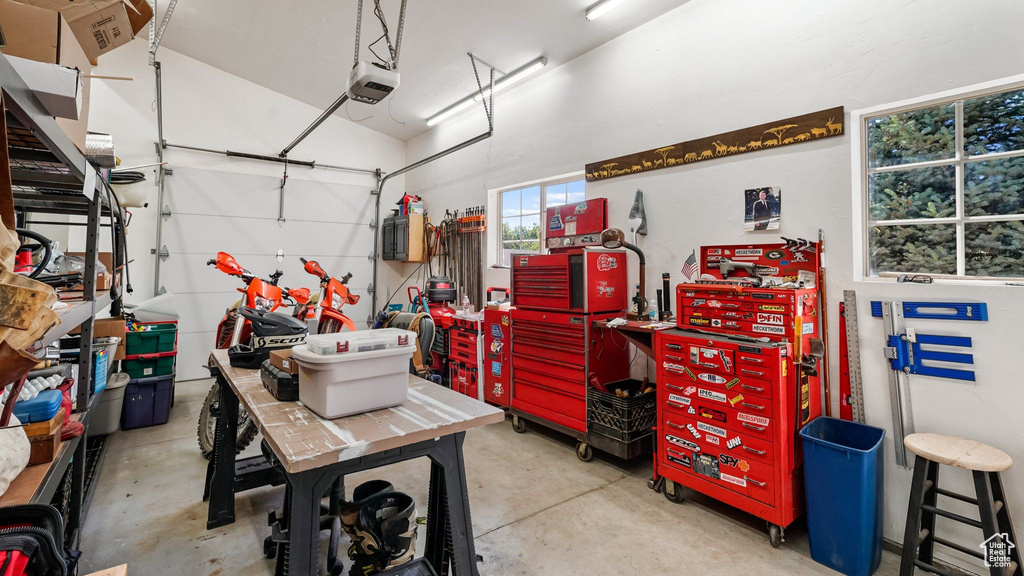 Garage with a workshop area and a garage door opener