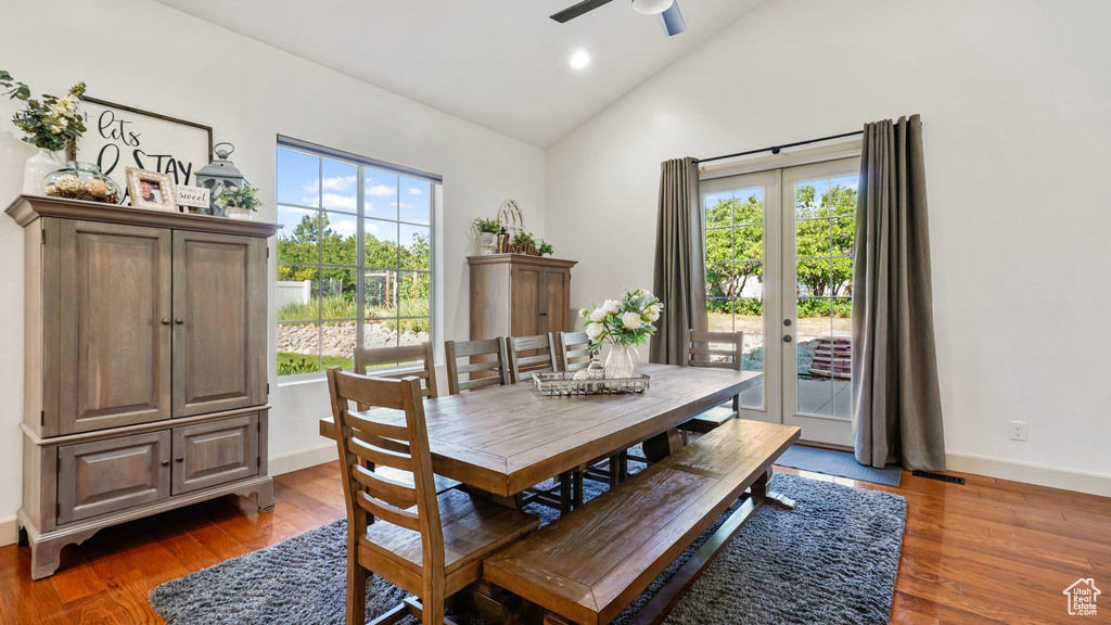 Dining area with high vaulted ceiling, a ceiling fan, wood finished floors, and recessed lighting