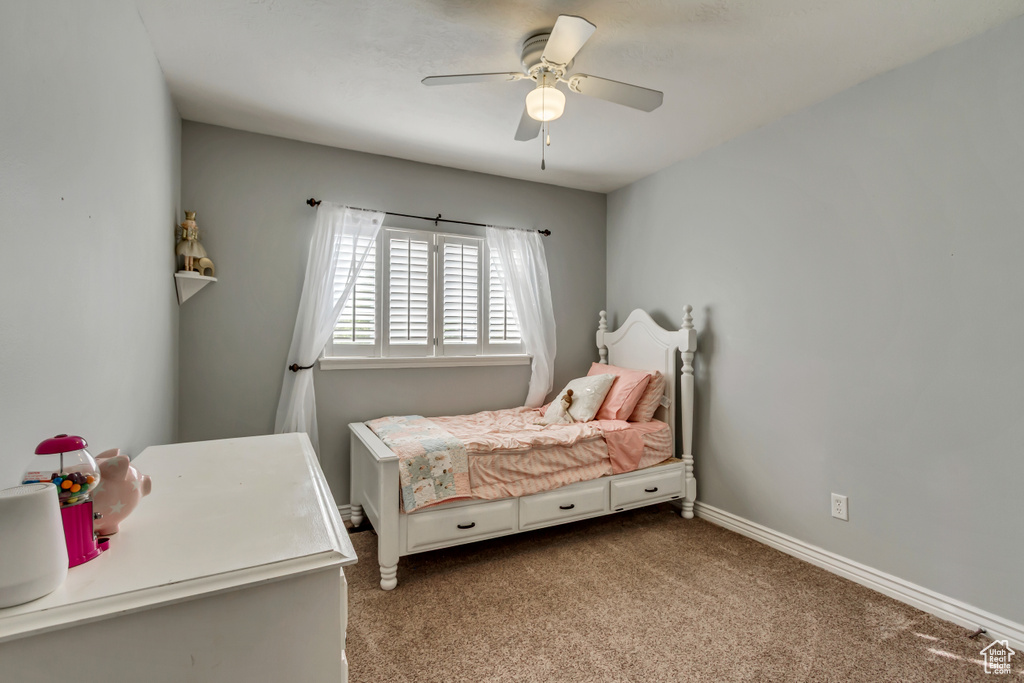 Carpeted bedroom with baseboards and ceiling fan