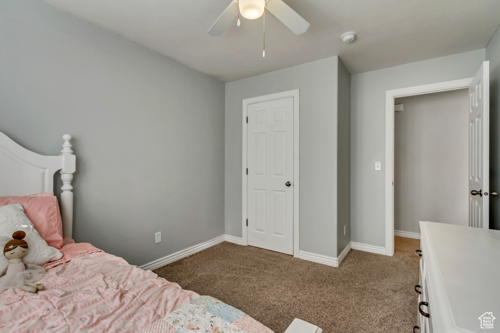 Bedroom with baseboards, carpet flooring, and ceiling fan