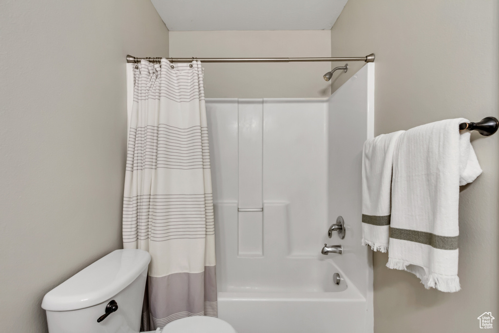 Full bathroom with shower / tub combo and toilet