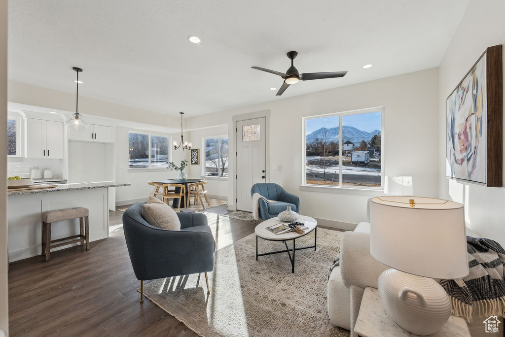 Living area featuring recessed lighting, dark wood-style flooring, and a mountain view