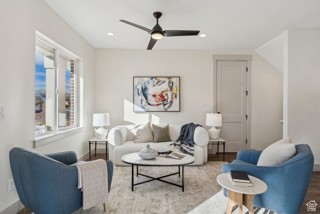 Living room with recessed lighting, a ceiling fan, wood finished floors, and baseboards