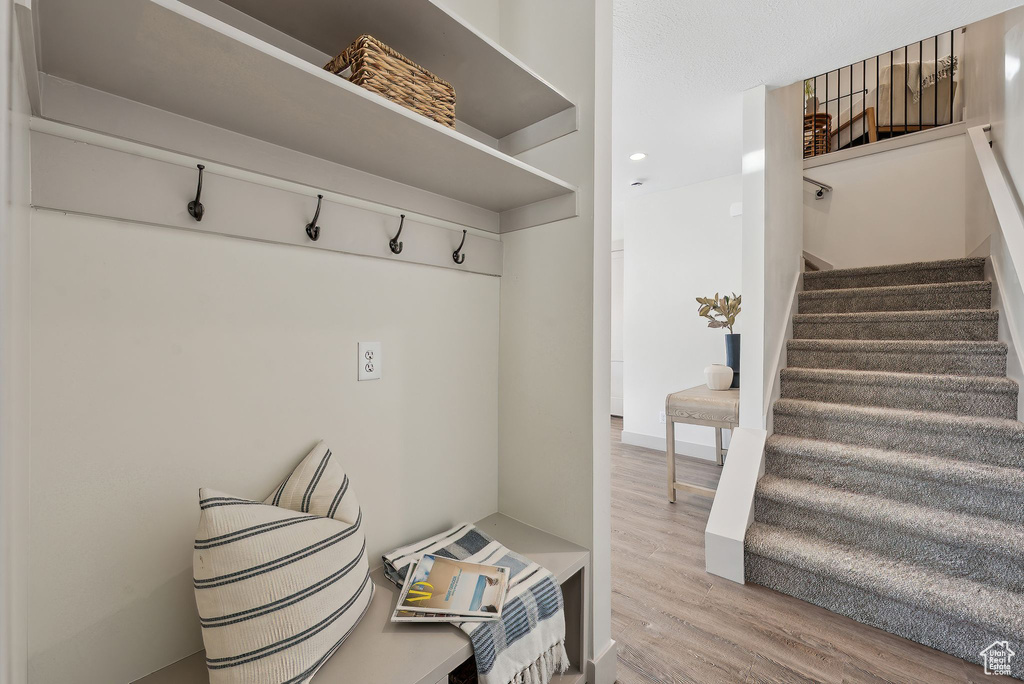 Mudroom with wood finished floors and recessed lighting