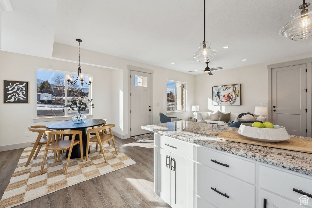 Kitchen featuring dark wood-style floors, recessed lighting, and white cabinetry