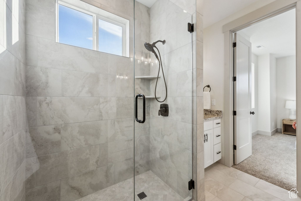 Bathroom with a shower stall and vanity