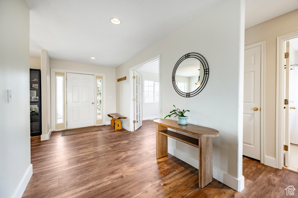 Entryway with baseboards, wood finished floors, and recessed lighting