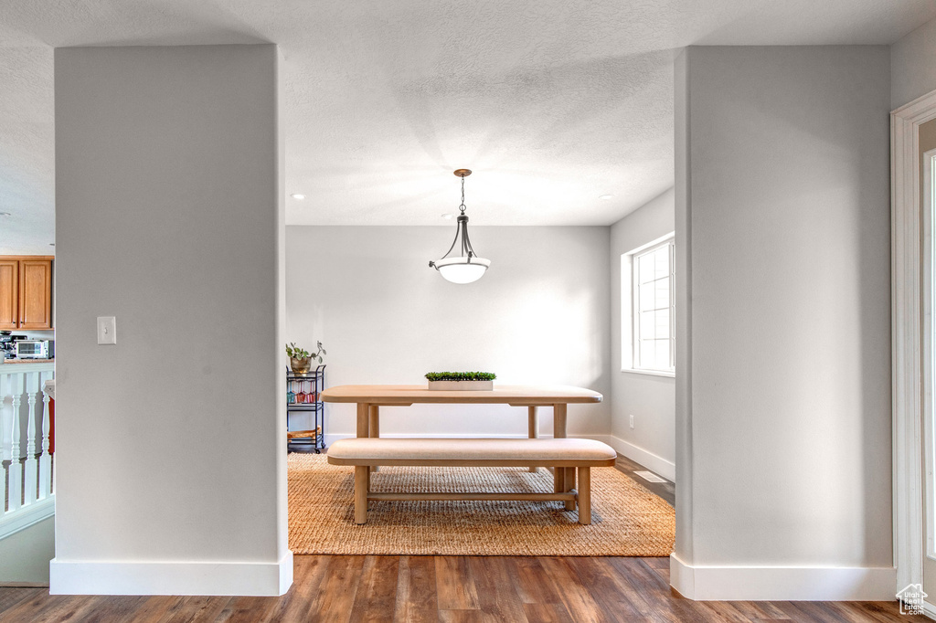 Dining space featuring baseboards and wood finished floors