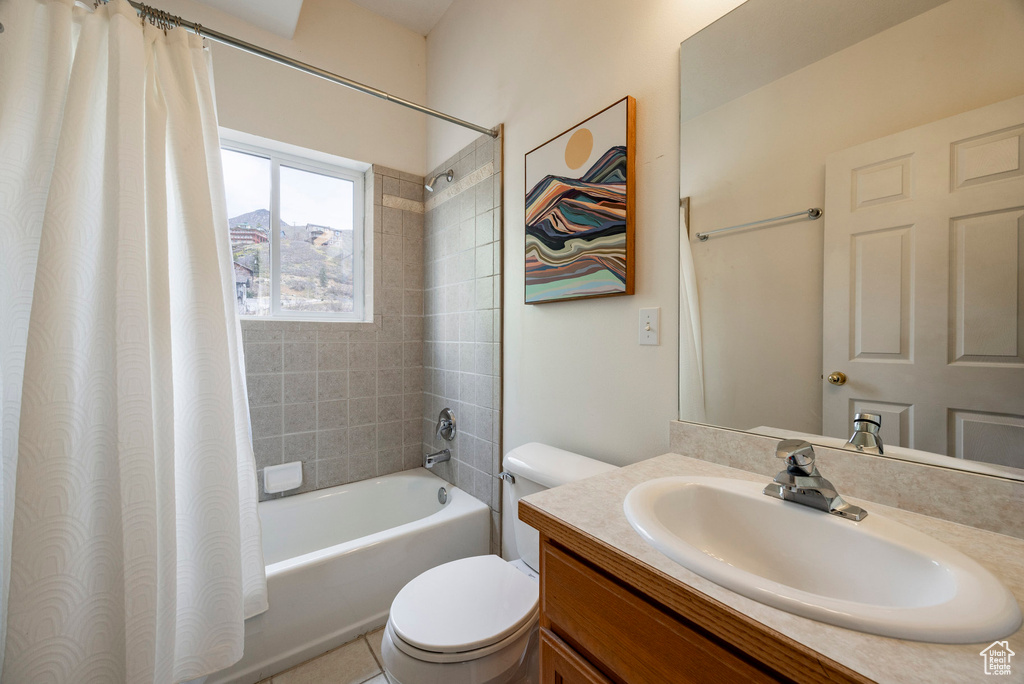 Bathroom with vanity, toilet, and shower / tub combo