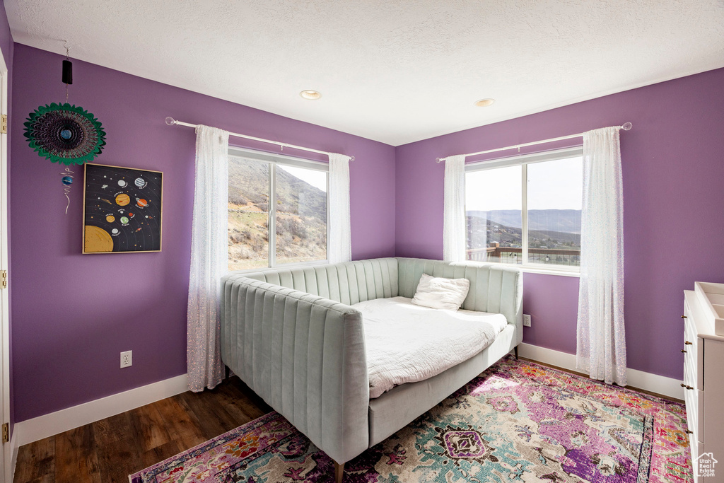 Bedroom with baseboards and wood finished floors