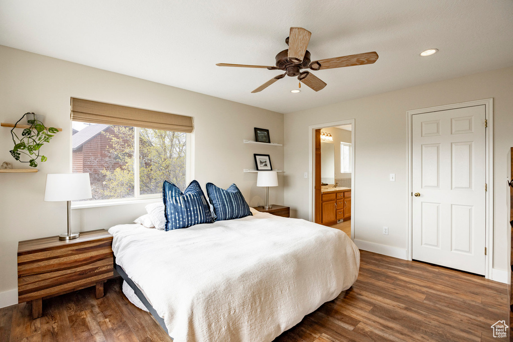 Bedroom featuring wood finished floors, recessed lighting, baseboards, ensuite bathroom, and ceiling fan