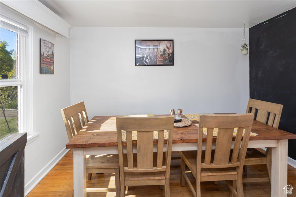 Dining area with light wood-style flooring, a wealth of natural light, and baseboards