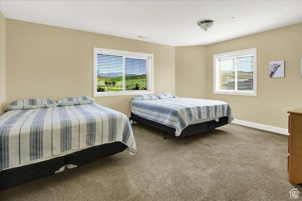 Carpeted bedroom with baseboards