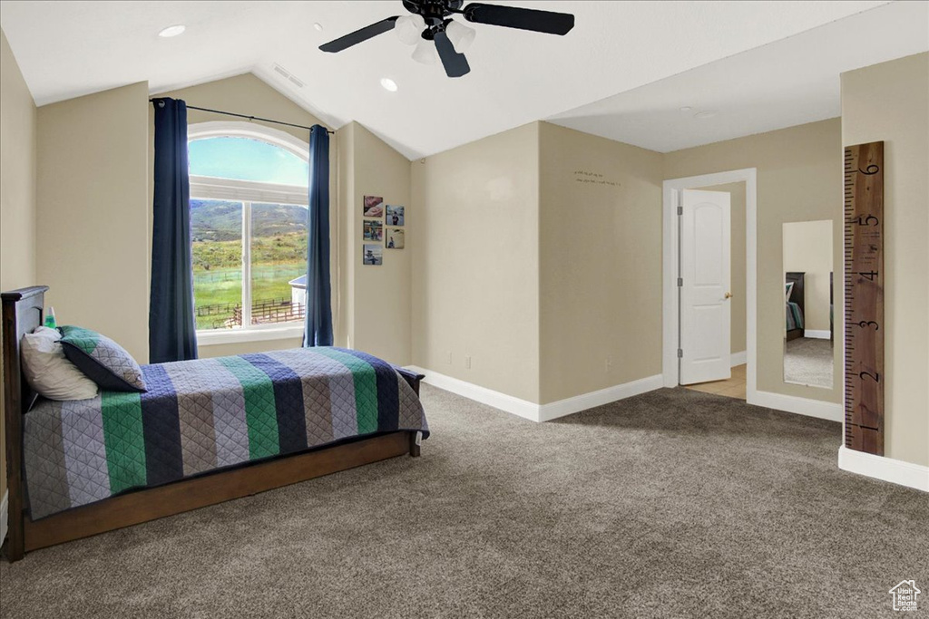 Bedroom with ceiling fan, visible vents, carpet, baseboards, and lofted ceiling