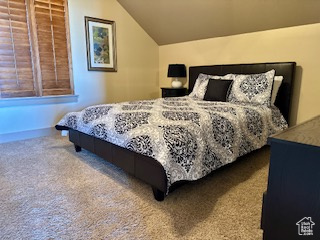 Carpeted bedroom with vaulted ceiling