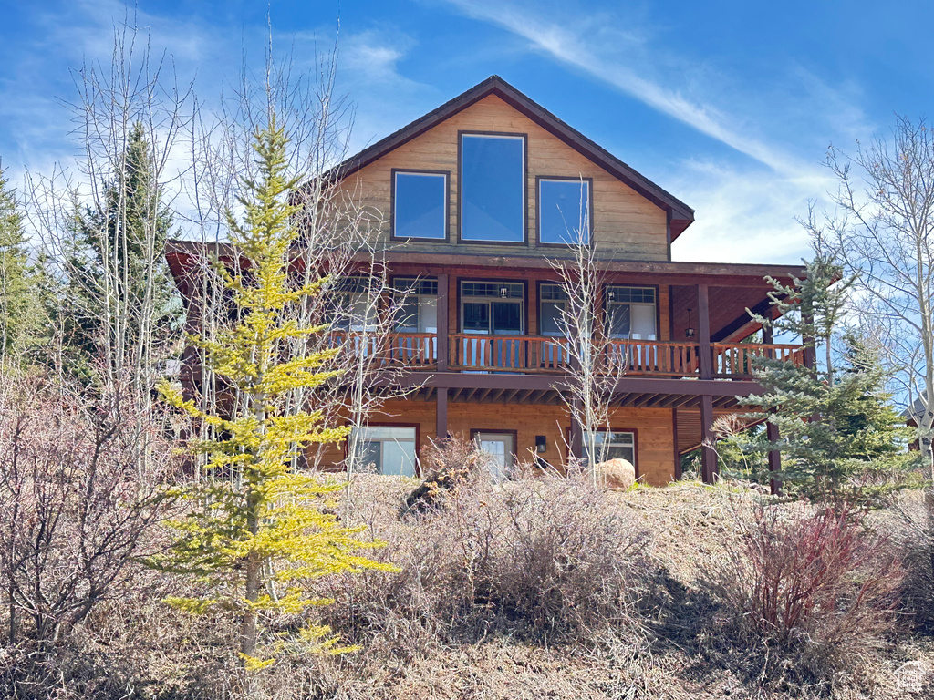 Back of property featuring a wooden deck