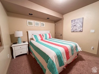 Carpeted bedroom featuring baseboards