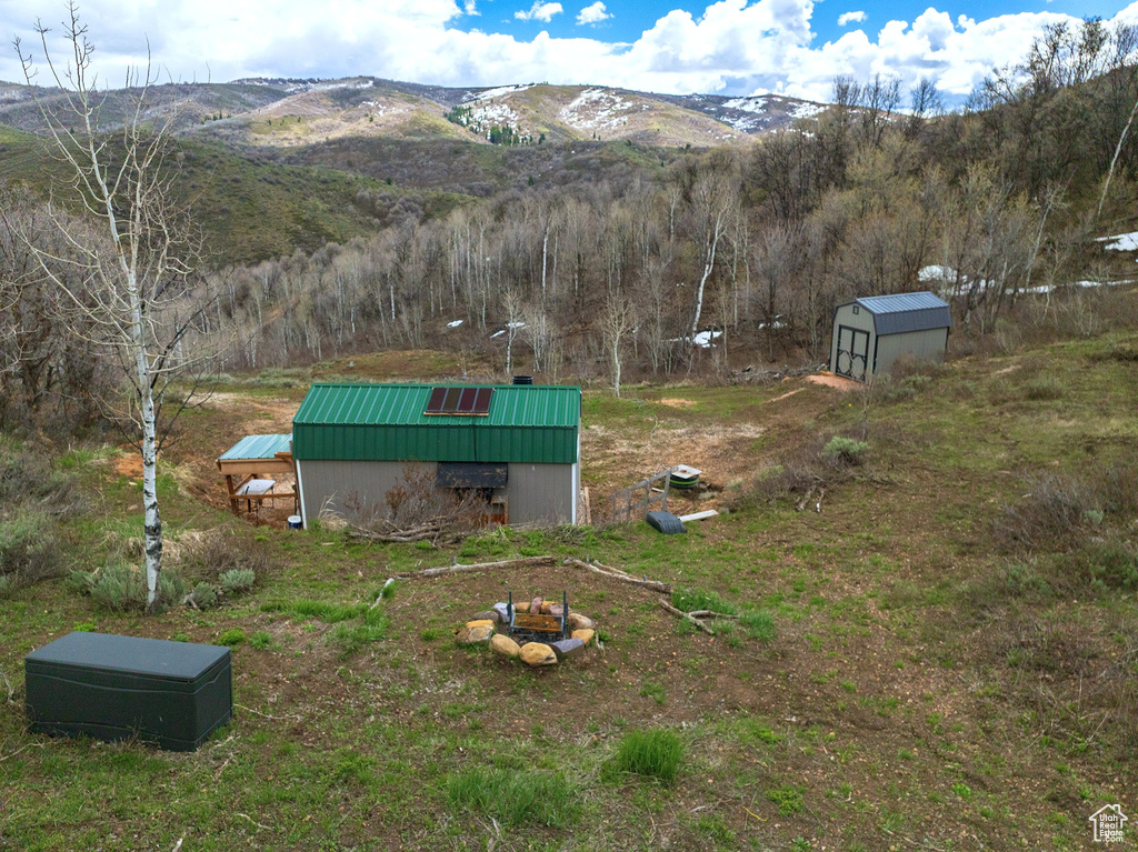 View of yard with a storage unit, an outbuilding, and a mountain view