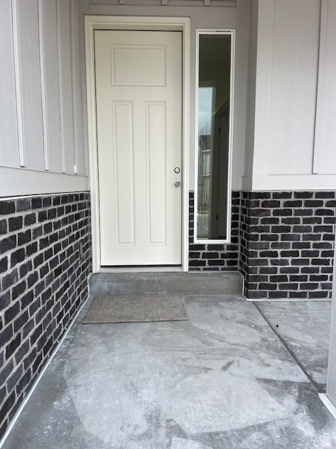 Entrance to property with brick siding