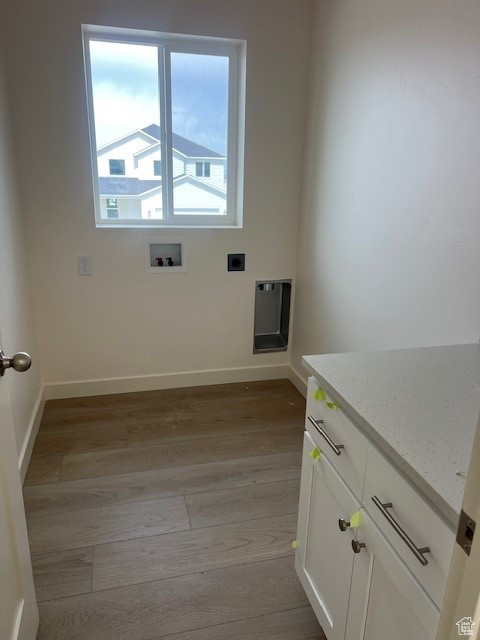 Unfurnished room with heating unit, light wood finished floors, and baseboards