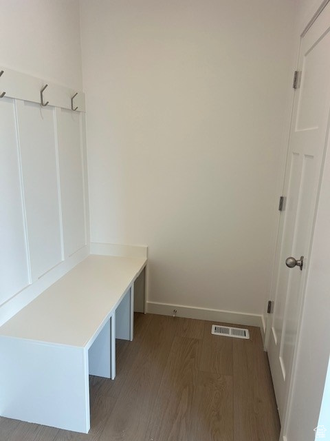 Mudroom featuring wood finished floors, visible vents, and baseboards