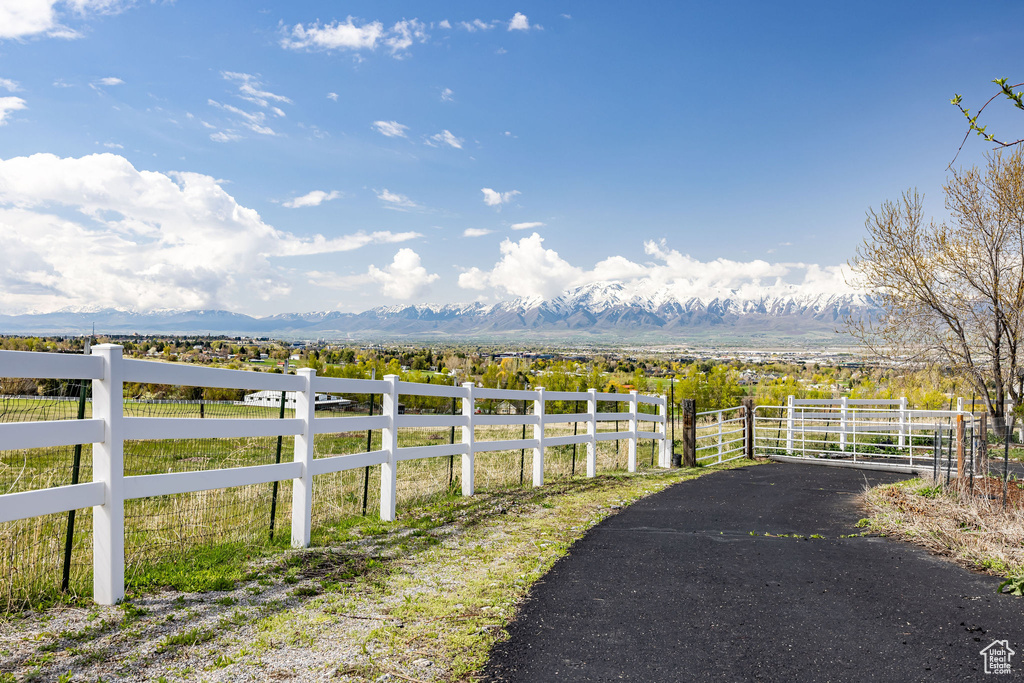 View of yard featuring fence, a rural view, and a mountain view