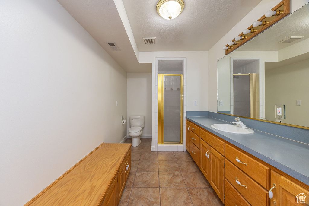 Full bath with vanity, visible vents, toilet, and a stall shower