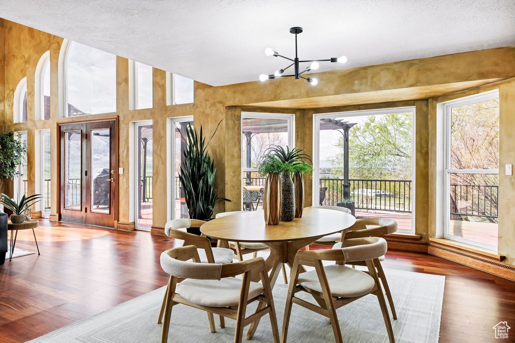 Dining area featuring an inviting chandelier and wood finished floors