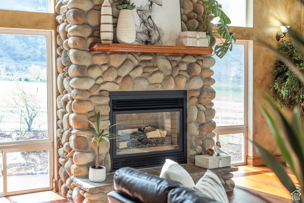 Interior details featuring a stone fireplace and wood finished floors