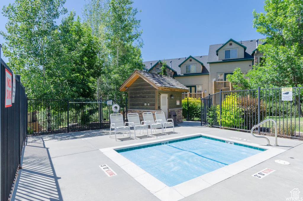 View of pool featuring fence, a patio, and a swimming pool