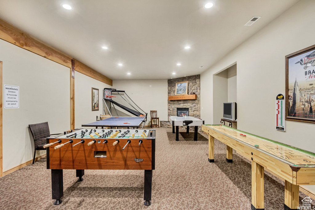 Game room featuring recessed lighting, a stone fireplace, carpet flooring, baseboards, and visible vents