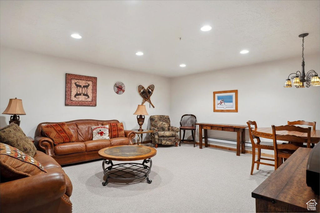 Living room with recessed lighting, a chandelier, and carpet