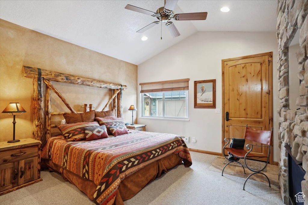 Bedroom with recessed lighting, a fireplace, ceiling fan, lofted ceiling, and light colored carpet