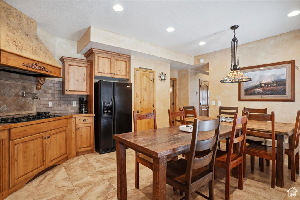 Dining area with recessed lighting and light tile patterned floors