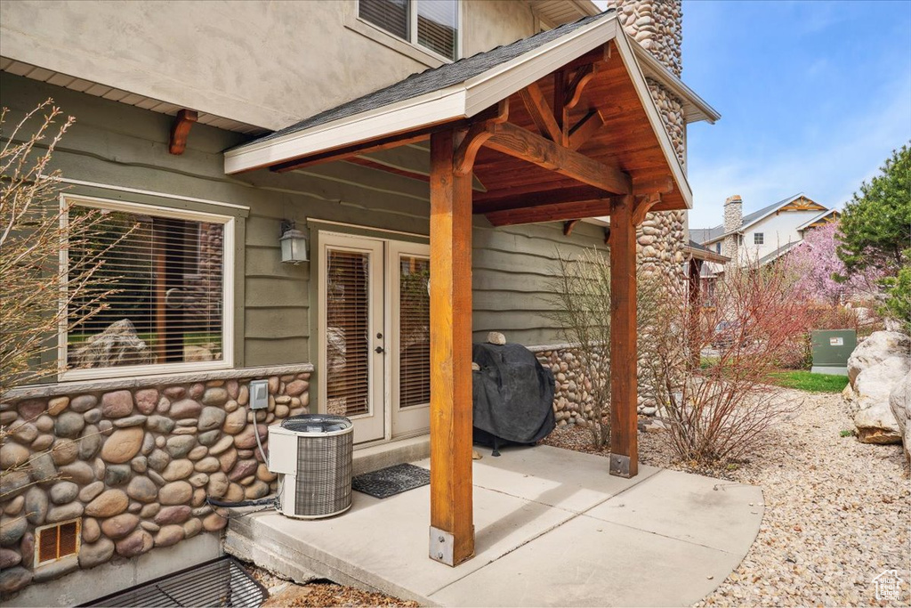 View of patio featuring area for grilling, central AC, and french doors