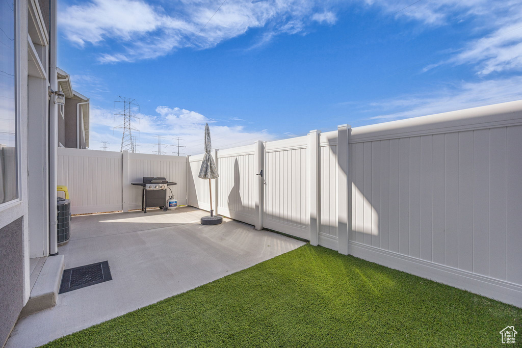 View of patio / terrace with a fenced backyard, visible vents, and grilling area