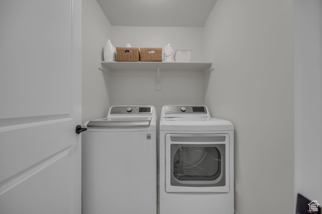 Laundry room with washer and clothes dryer and laundry area