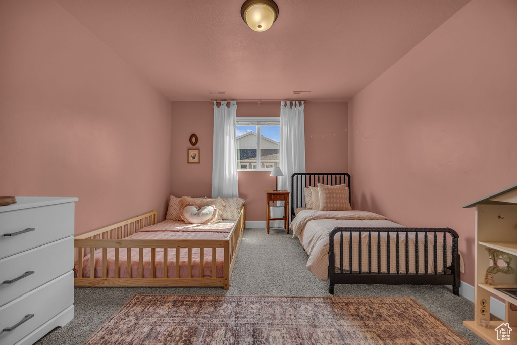 Carpeted bedroom featuring baseboards