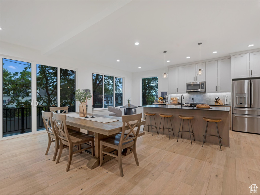 Dining space with recessed lighting and light wood-style floors