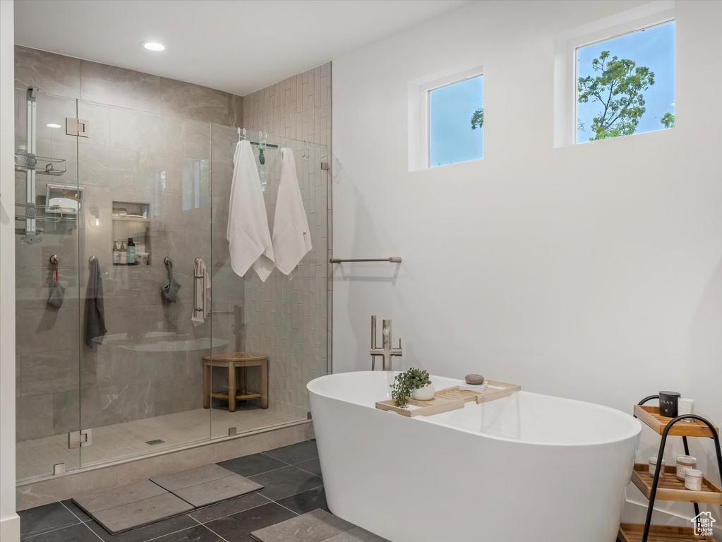Full bathroom with a freestanding tub, recessed lighting, and a shower stall
