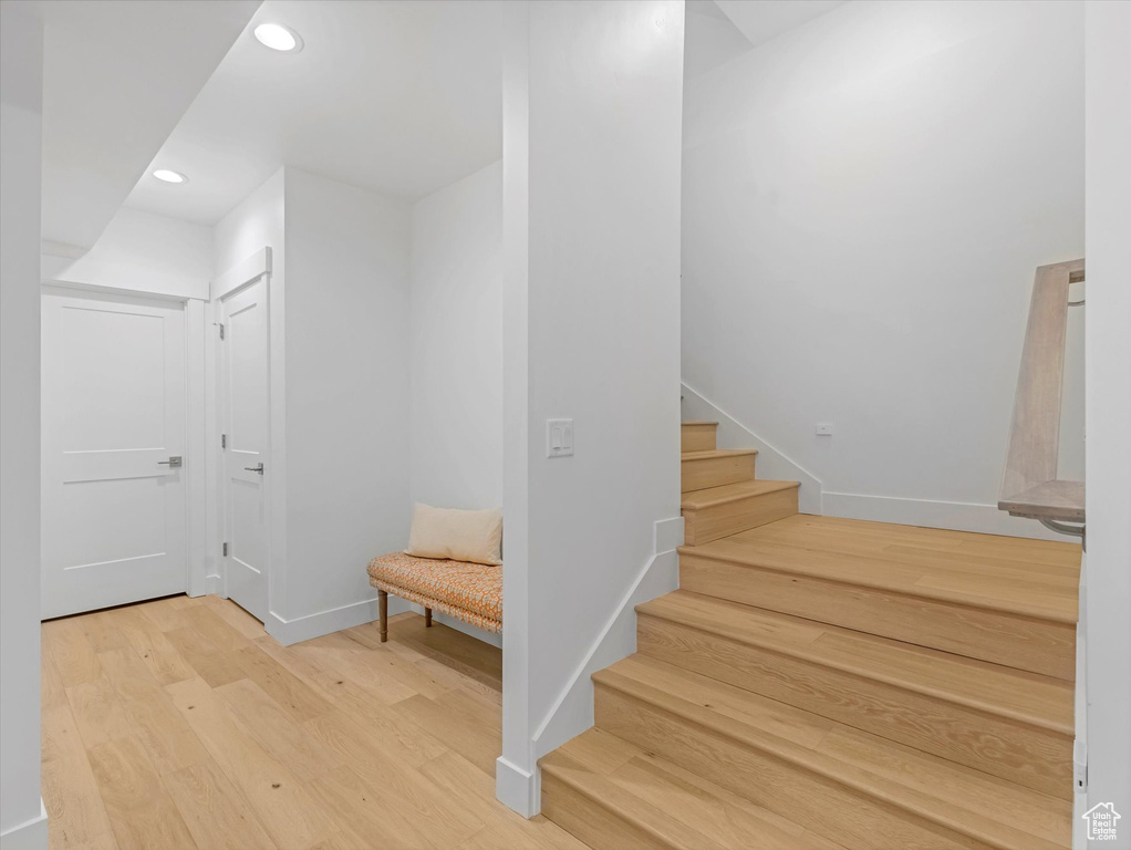 Stairs featuring baseboards, recessed lighting, and wood finished floors