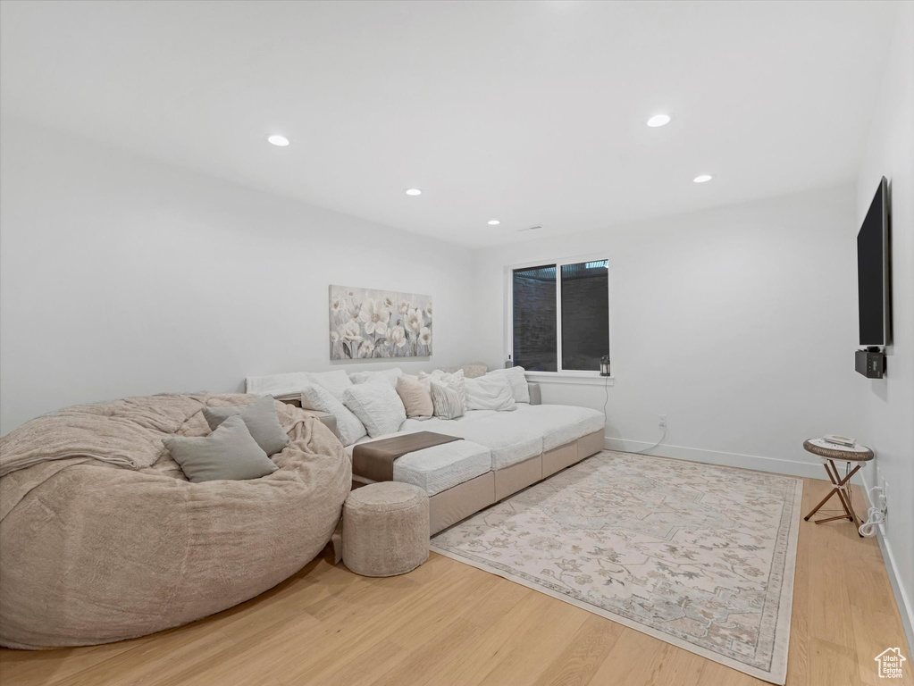 Living area with baseboards, recessed lighting, and wood finished floors