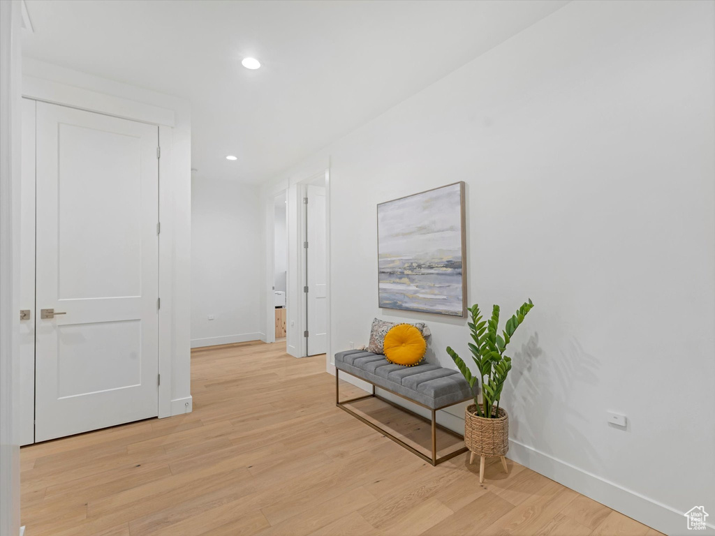Hall featuring light wood-type flooring, recessed lighting, and baseboards