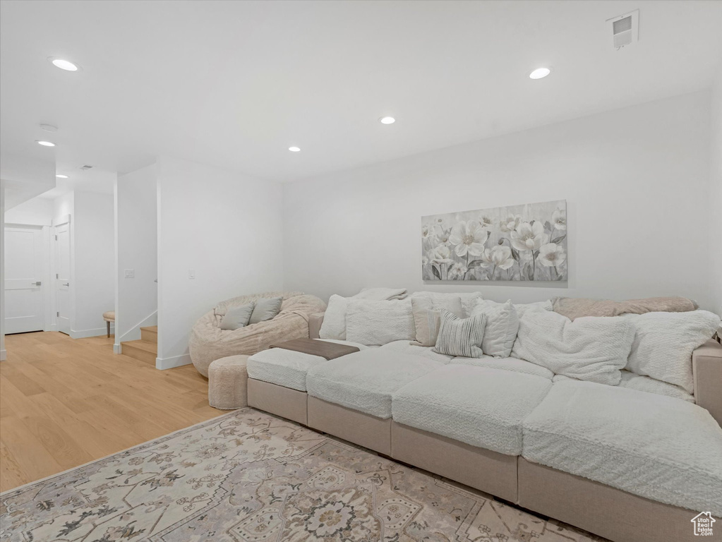 Living area with stairway, wood finished floors, recessed lighting, and visible vents